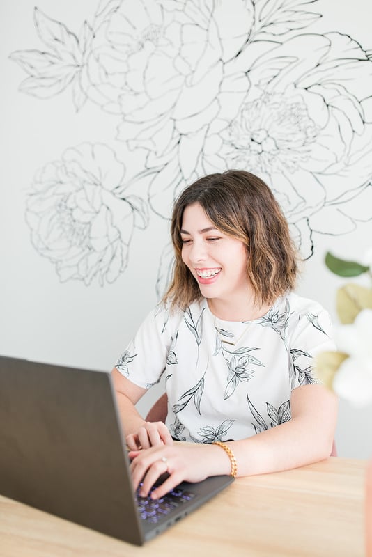 wichita small business mentor woman smiles looking at laptop